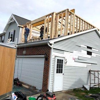 Premier Remodeling - a man on the roof of a house - General Contractors Near Me Premier Remodeling - a man on the roof of a house - General Contractors Near Me