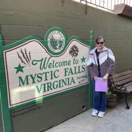 Me by the painted Welcome to Mystic Falls sign before getting on our tour