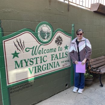 Main Street Trolleys - Me by the painted Welcome to Mystic Falls sign before getting on our tour - Bus Tours Near Me - Covington, Georgia