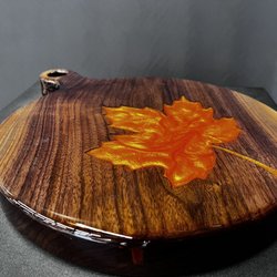 Grand Inspired - "Maple Leaf Charcuterie Board"  Made with black walnut, resin and ultra shiny finish.  Available in the gallery.