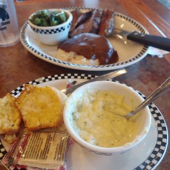 Black Bear Diner Lodi - Forefront: cup of broccoli cheese soup with cornbread muffin. Background: 6 oz. Tri Tip dinner w/mash potatoes/gravy and green beans. - American Near Me - Lodi, California