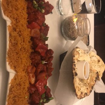 Cholanad - Gobi Manchurian on Tomato Pulav Rice with Garlic Naan Bread. For one person. Needless to say there are lots of leftovers. - Indian Near Me - Chapel Hill, North Carolina