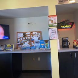 Waiting area with snacks. Free coffee and assortment of beverages in fridge to the right.