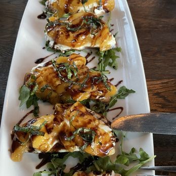 Uva Wine Bar - Warm peach & buratta bruschetta with arugula and balsamic - Wine Bars Near Me - Colorado Springs, Colorado Uva Wine Bar - Warm peach & buratta bruschetta with arugula and balsamic - Wine Bars Near Me - Colorado Springs, Colorado