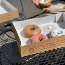 a box of doughnuts on a table a box of doughnuts on a table