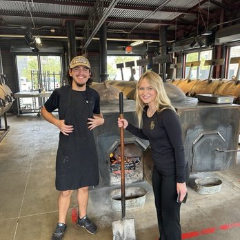 Terry Black's Barbecue - Waco - Jena stoking the Terry Black fire.. - Barbeque Near Me - Waco, Texas