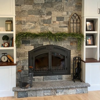 American Masonry Construction - Indoor fireplace constructed with stacked natural stone veneer in varied gray and brown tones, featuring a large black arched fireplace inse - Masonry/Concrete Near Me - Henniker, New Hampshire American Masonry Construction - Indoor fireplace constructed with stacked natural stone veneer in varied gray and brown tones, featuring a large black arched fireplace inse - Masonry/Concrete Near Me - Henniker, New Hampshire