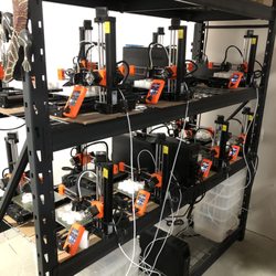 Madboxx Designs - Our Prusa Mini+ farm of 15 printers actively turning out 150 board game pieces a day for our customers.