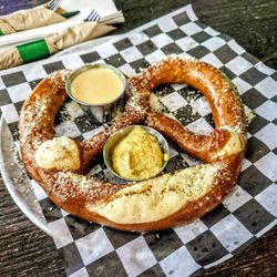Jumbo Pretzel: Served warm, brushed with garlic butter and dusted with parmesan. Served with Solace beer cheese and mustard.