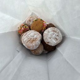 Assorted dozen of donut holes. The powder one is bavarian cream. The filling is delicious. Assorted dozen of donut holes. The powder one is bavarian cream. The filling is delicious.