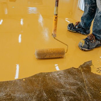 Impact Coating Solutions - a man using a roller to paint a floor - Flooring Near Me - Mesa, Arizona