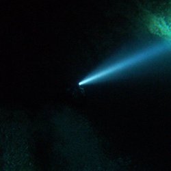 Paradise Springs - A lone flashlight checking out the cavern walls