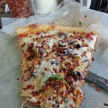 Fellini's Pizza - A slice of the Special with tons of red pepper.  My favorite! - Pizza Near Me - Atlanta, Georgia