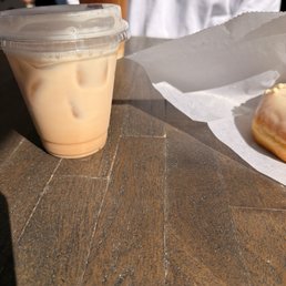 Iced chai latte, iced coffee and Tunisian vanilla frosted doughnut Iced chai latte, iced coffee and Tunisian vanilla frosted doughnut