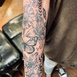 Atomic Tattoos - Lower arm half sleeve.. flowers and butterflies. By tattoo artist Jay Boss.
