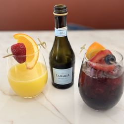 Keke's Breakfast Cafe - LEFT: White peach bellini (bottle in center). RIGHT: Wild berry sangria