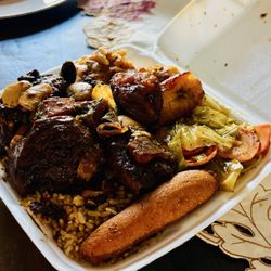 Rasta Belly - Oxtail Plate comes with Mac&Cheese, oxtails, rice & beans, cabbage and carrots, plantains and a roll ( I think that's what it's called)