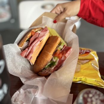 Two Brothers Pizza - a sandwich and chips on a table - Pizza Near Me - Kendall, Florida Two Brothers Pizza - a sandwich and chips on a table - Pizza Near Me - Kendall, Florida