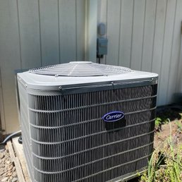 Our new Heat Pump - both cools and heats. Also Electrical installation at the back of the photo shows the great work they did!
