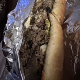 Steak and Cheese Sub With lettuce, onions, black olives, and banana peppers. Steak and Cheese Sub With lettuce, onions, black olives, and banana peppers.