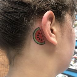 Baltimore Tattoo Museum - Melon tattoo behind ear from artist Ian Smith