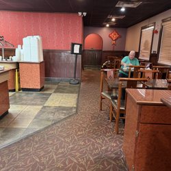 Side dining and bathroom, can see the mini fridge by the register.
