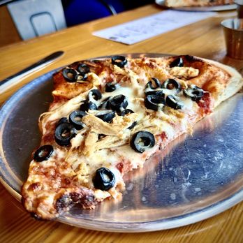 Noli's Pizzeria - Blackstone - Lunch Slice with Spicy Chicken and Black Olives - Pizza Near Me - Omaha, Nebraska