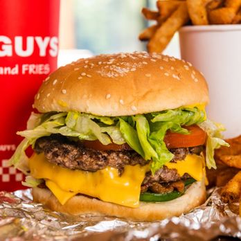 Five Guys - A close-up photograph of a Five Guys cheeseburger, soft drink in red Five Guys cup, and regular order of fries sitting on a t... - Burgers Near Me - Frisco, Texas Five Guys - A close-up photograph of a Five Guys cheeseburger, soft drink in red Five Guys cup, and regular order of fries sitting on a t... - Burgers Near Me - Frisco, Texas