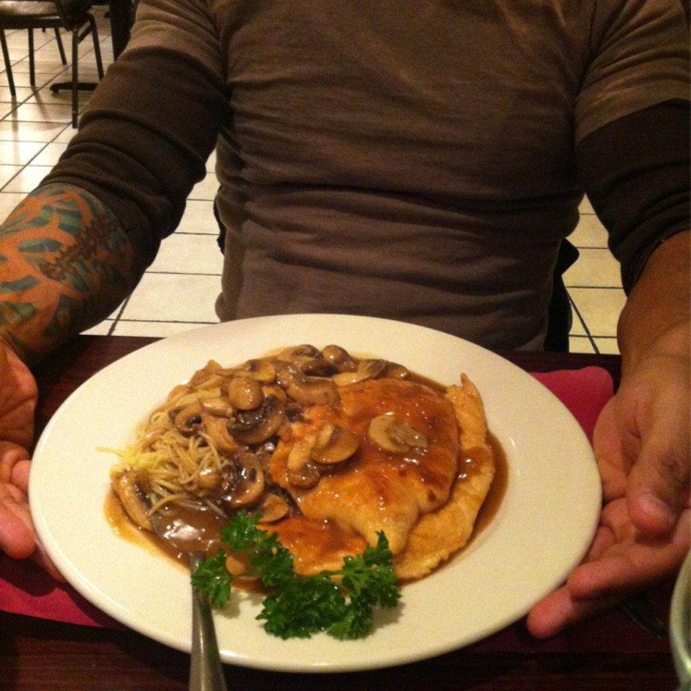 a man holding a plate of food a man holding a plate of food
