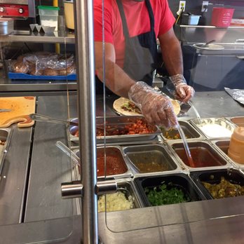 John Juan - a man preparing food in a buffet - Mexican Near Me - Ottawa, Ontario