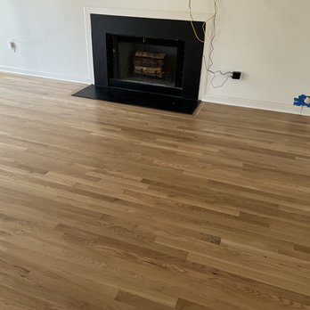 Quality Hardwood - a fireplace in a living room - Flooring Near Me - Fuquay Varina , North Carolina