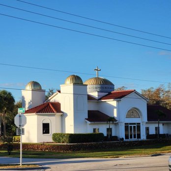 Ace Roofing & Construction - a white church with a red roof - General Contractors Near Me
