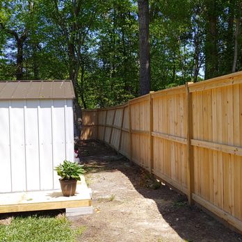 Mane Construction - a fence with a potted plant - General Contractors Near Me - Clayton, North Carolina
