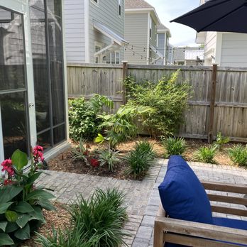Cypress Landscaping & Design - a patio with a bench and umbrella - Landscaping Near Me Cypress Landscaping & Design - a patio with a bench and umbrella - Landscaping Near Me