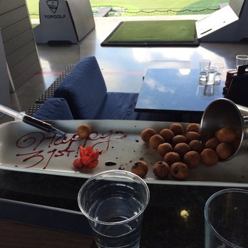 Topgolf - The most delicious little donuts with filling you inject on your own (the sauce comes in fake needles). Yes they are half eaten. - New American Near Me - Naperville, Illinois