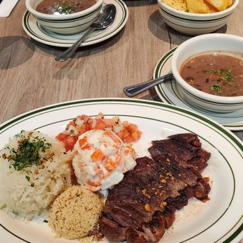 Basil Brazil Cuisine - Two steak carioca plates, one with yuca fries and the other with potato salad - Brazilian Near Me - San Juan Capistrano, California