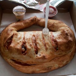 Philadelphia Style Pizza - Calzone easily feeds two. The plastic fork is used to show scale.