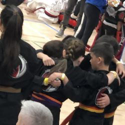 Impact Martial Arts - Teamwork - they are all competing in the same division against each other.  This is them huddling before they enter the ring.