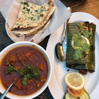 Kathakali - Meen Pollichathu (sea bass fish wrapped in banana leaf), Kerala Chicken Curry and Garlic Naan - Indian Near Me - Kirkland, Washington Kathakali - Meen Pollichathu (sea bass fish wrapped in banana leaf), Kerala Chicken Curry and Garlic Naan - Indian Near Me - Kirkland, Washington