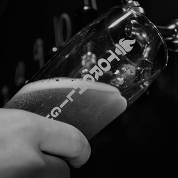 Torchlight Brewing - a person pouring a beer into a glass - Breweries Near Me - Nelson, British Columbia Torchlight Brewing - a person pouring a beer into a glass - Breweries Near Me - Nelson, British Columbia
