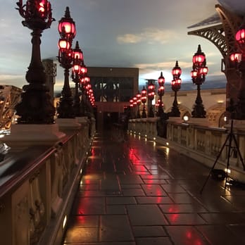 Eiffel Tower Viewing Deck - Bridge from the escalator to the elevator.  Photographer takes a pic that you can buy later if you want to - Amusement Parks Near Me - Las Vegas, Nevada
