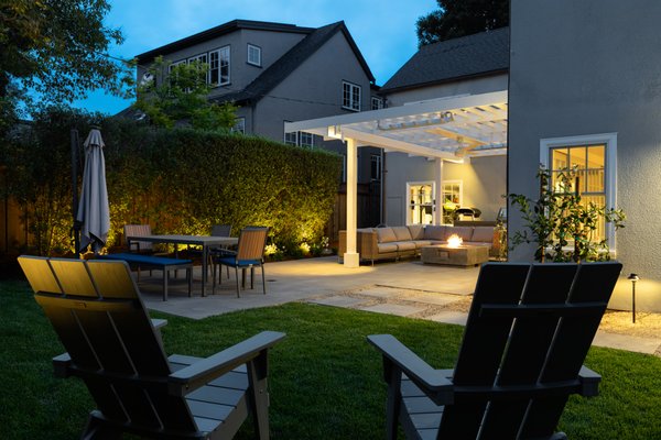 Burlingame Contemporary Outdoor Living & Landscape Design-Build - This contemporary landscape design brings a perfect balance of style and functionality to both the front and backyard, creating a seamless outdoor living experience. The backyard design features an expansive paver patio, offering a durable and elegant foundation for relaxation and entertainment. A sleek modern fire pit serves as the focal point of the outdoor seating area, framed by a stylish patio cover that provides shade while maintaining an open, airy feel.

Concrete stepping stones add a dynamic element to the space, leading through a well-manicured grass install and carefully selected backyard landscaping that enhances the home’s natural beauty. Thoughtfully placed landscape lighting transforms the space in the evening, creating a warm, inviting ambiance.

In the front yard, the transformation continues with a lush lawn, an elegant walkway, and an updated entryway, all designed to complement the home’s architecture. The refreshed landscape design introduces layers of color and texture, providing stunning curb appeal while maintaining a clean, modern aesthetic.

From its stylish hardscaping to its functional outdoor living areas, this project is a true testament to the power of a well-executed paver patio and expert landscape designer craftsmanship. Whether hosting gatherings or enjoying a quiet evening by the fire, this outdoor living space is built for year-round enjoyment.

Opulands is a family-owned Bay Area company specializing in comprehensive landscape and hardscape design and installation. We transform outdoor spaces into stunning retreats by blending softscaping elements like lawns and gardens with hardscaping features such as paver driveways, patios, and outdoor kitchens. Our team is dedicated to creating functional and opulent environments that enhance your lifestyle. Experience the beauty and functionality of a meticulously designed outdoor space. Call us today at 844-306-8953 for more information.