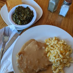 Smothered pork chops, Macaroni and cheese, greens, corn bread Smothered pork chops, Macaroni and cheese, greens, corn bread