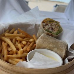 The Caribe Bar and Grill - Club Wrap with chicken, bacon, fried egg, tomato, lettuce, avocado, aioli