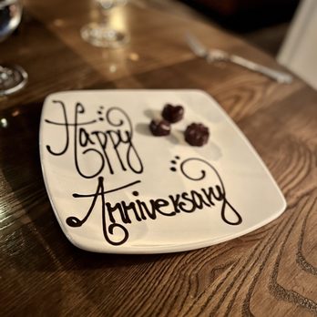 Coral - a happy anniversary plate on a table - Seafood Near Me - Greenville, South Carolina