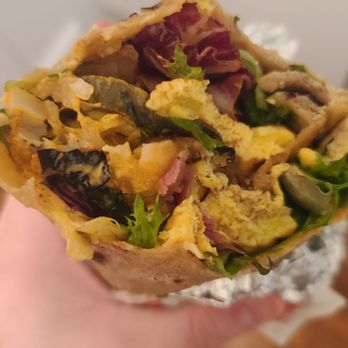 Wolfnights® - a hand holding a sandwich - New American Near Me - New York, New York Wolfnights® - a hand holding a sandwich - New American Near Me - New York, New York