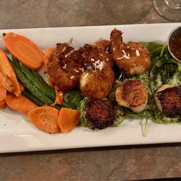 Daily special. Scallops & coconut prawns on a bed of wilted spinach topped w/homemade pesto. Daily special. Scallops & coconut prawns on a bed of wilted spinach topped w/homemade pesto.