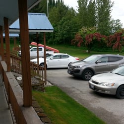 The Circle Motel & Sporting Goods Store - View from the porch in front of our room. Horseshoe pits are near the red trees.