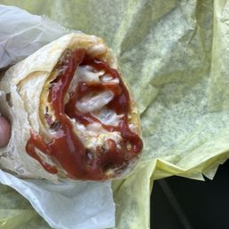Breakfast burrito sausage bacon with gravy and hot taco sauce Breakfast burrito sausage bacon with gravy and hot taco sauce