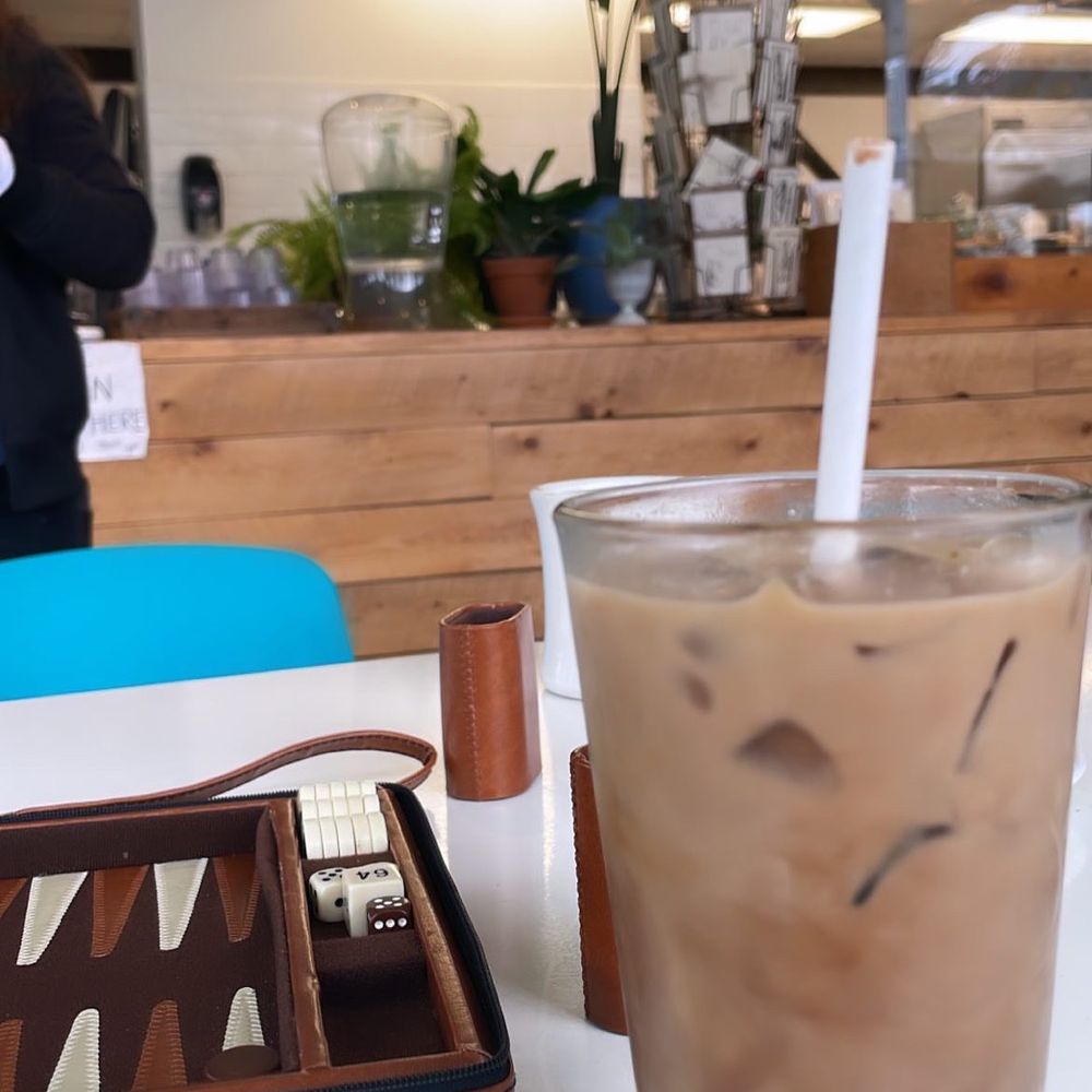 Scout - a glass of iced coffee and a game board - Coffee & Tea Near Me - Burlington, Vermont Scout - a glass of iced coffee and a game board - Coffee & Tea Near Me - Burlington, Vermont
